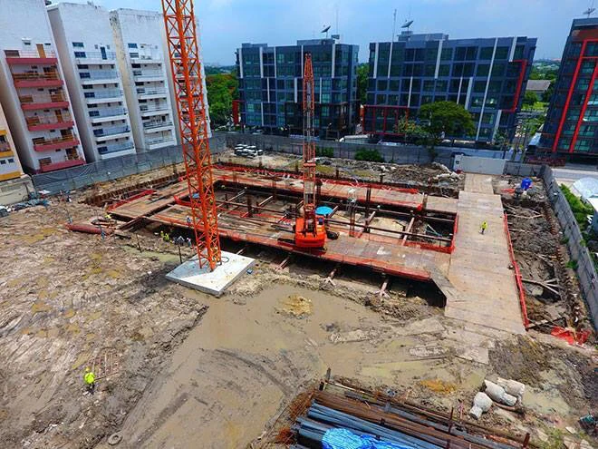 Wide view of excavation and bracing at an office construction site